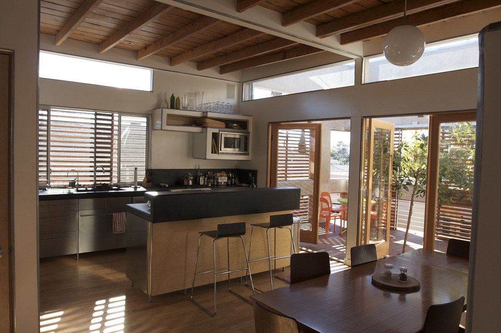 Finished open-plan kitchen with a wood-beamed ceiling and island seating